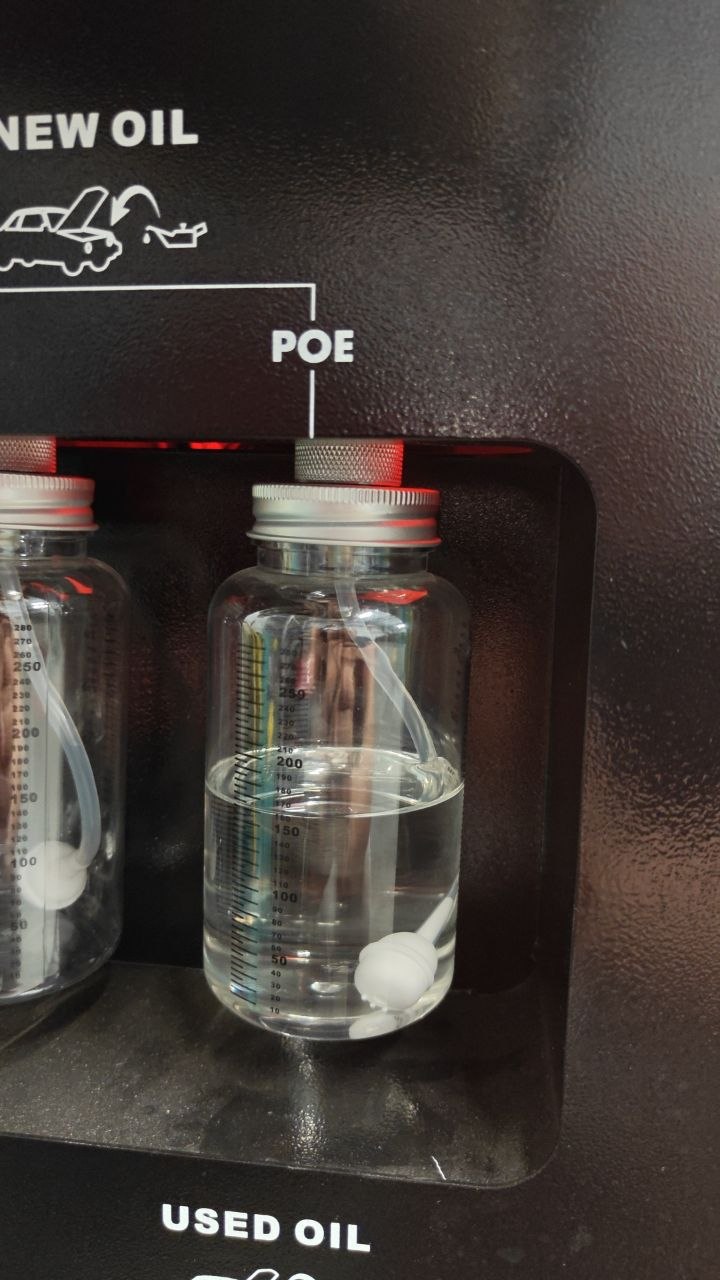 A proper A/C service station: separate oil bottles — the POE bottle is the one that must be used for a Tesla