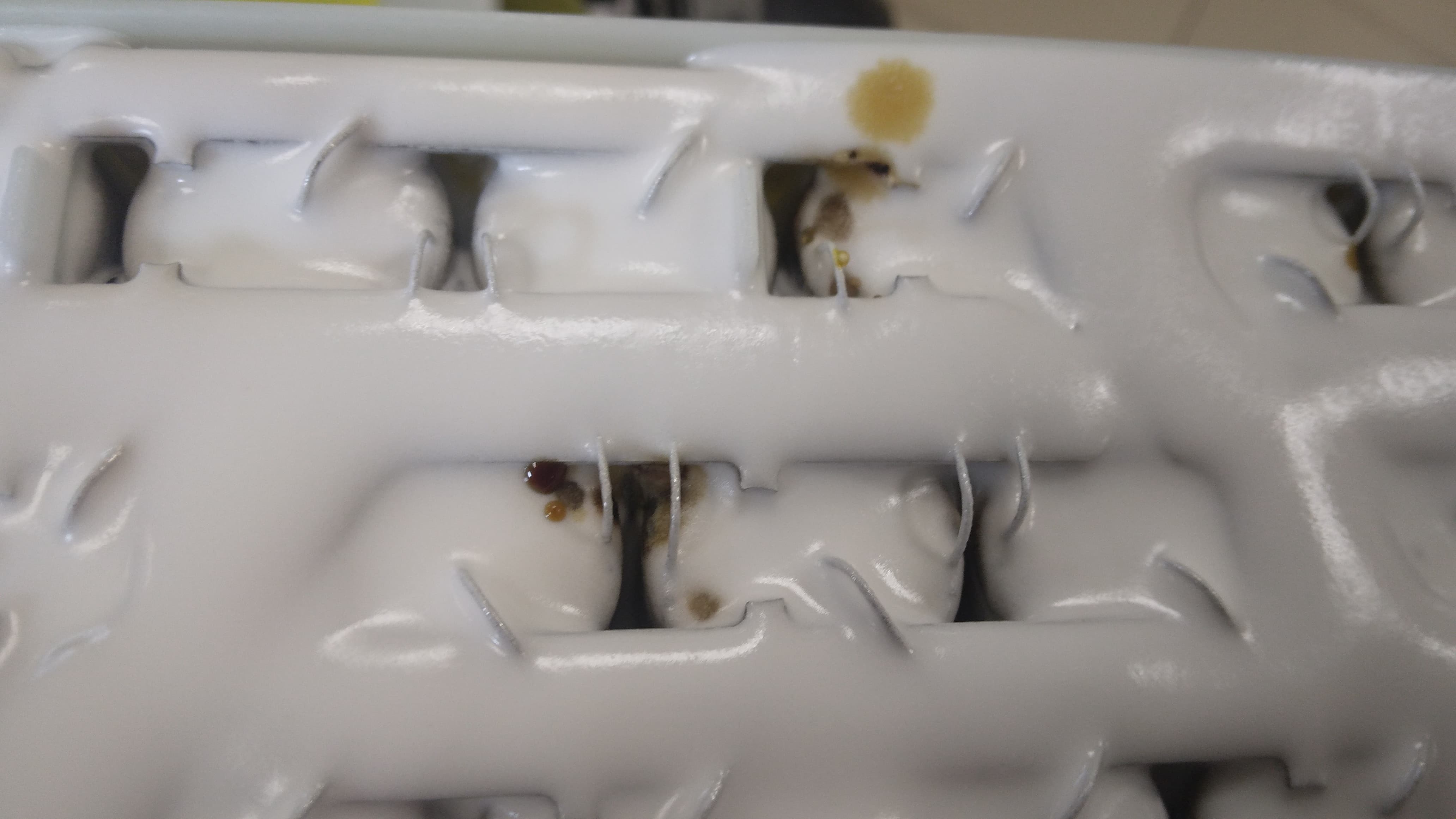 Electrolyte drops and deposits on the module's top plate — the leak is progressing