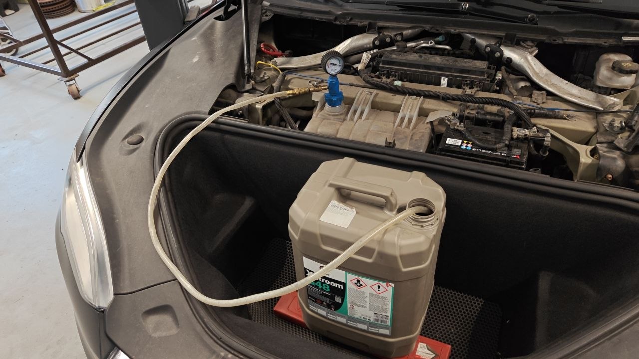Vacuum pulls coolant into the system from the canister through the hose